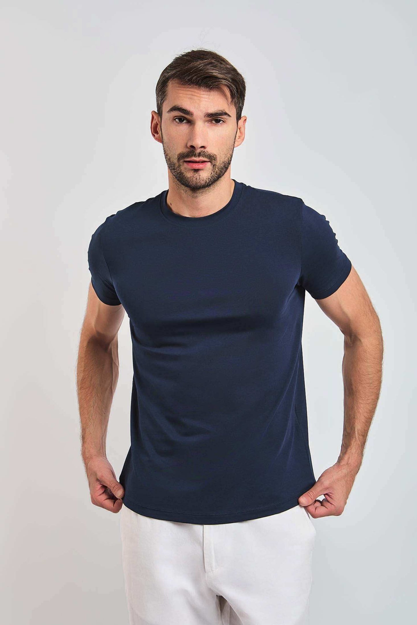 Dalydress men’s casual navy blue t-shirt with short sleeves, model wearing white pants