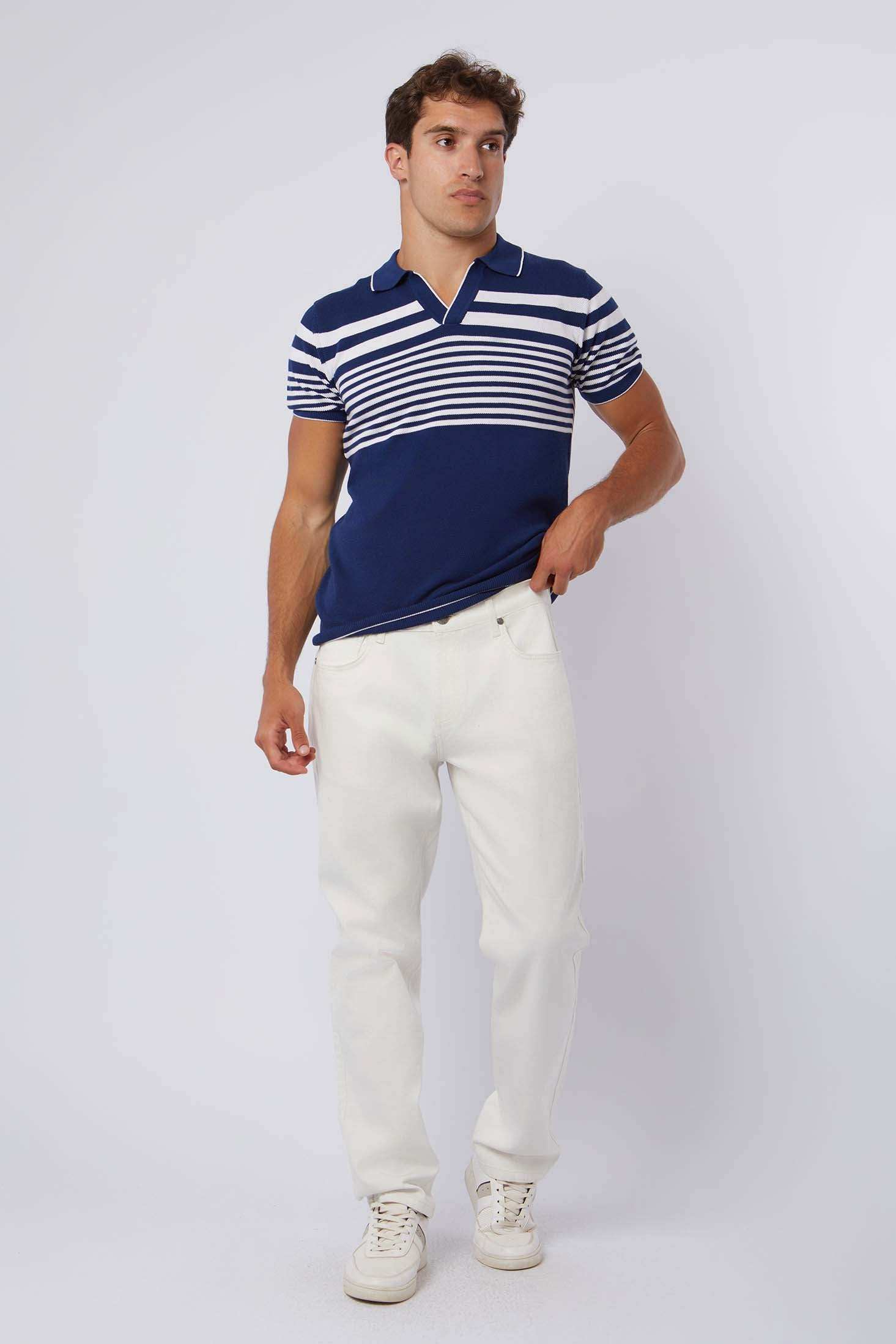 Man wearing Dalydress blue striped polo shirt and white pants, casual men's fashion