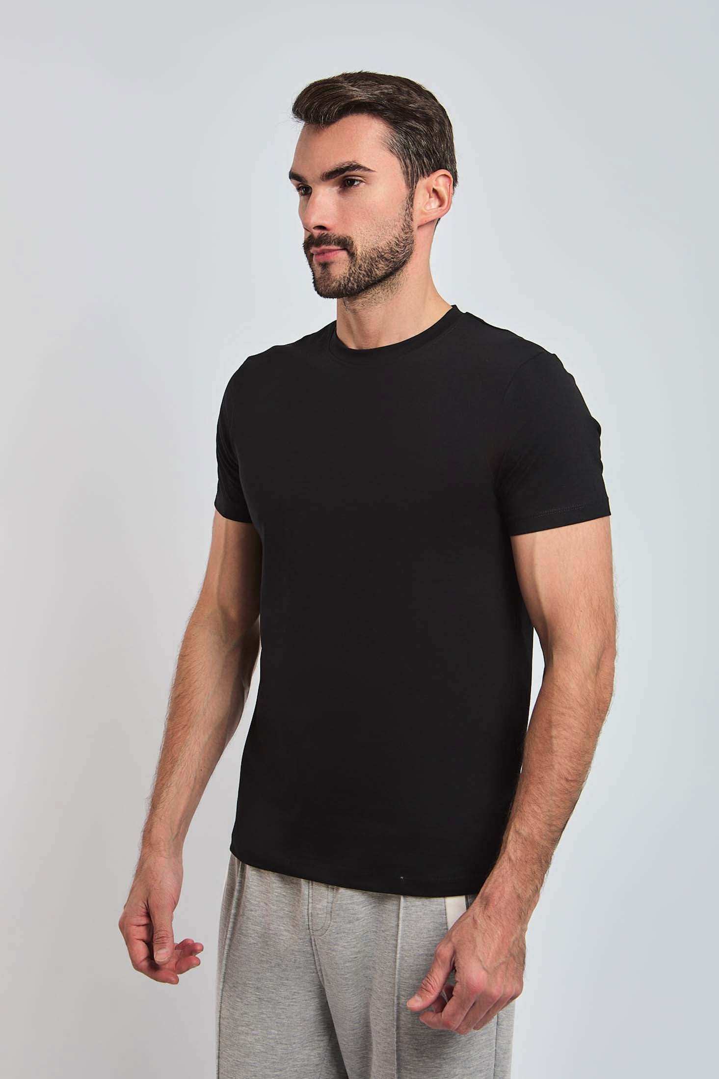 Dalydress men's black crew neck t-shirt with short sleeves, modeled with grey pants