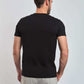 Dalydress men's black short sleeve t-shirt, back view, paired with light grey pants