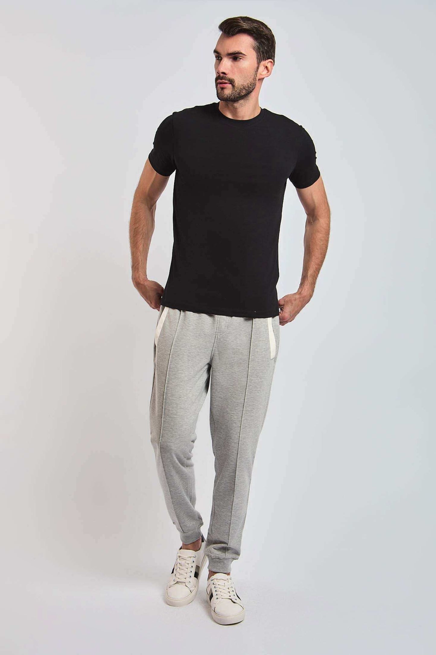 Dalydress men's casual outfit with black t-shirt, grey jogger pants, and white sneakers