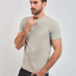 Male model in a light grey short-sleeve Dalydress t-shirt and black jeans against plain background