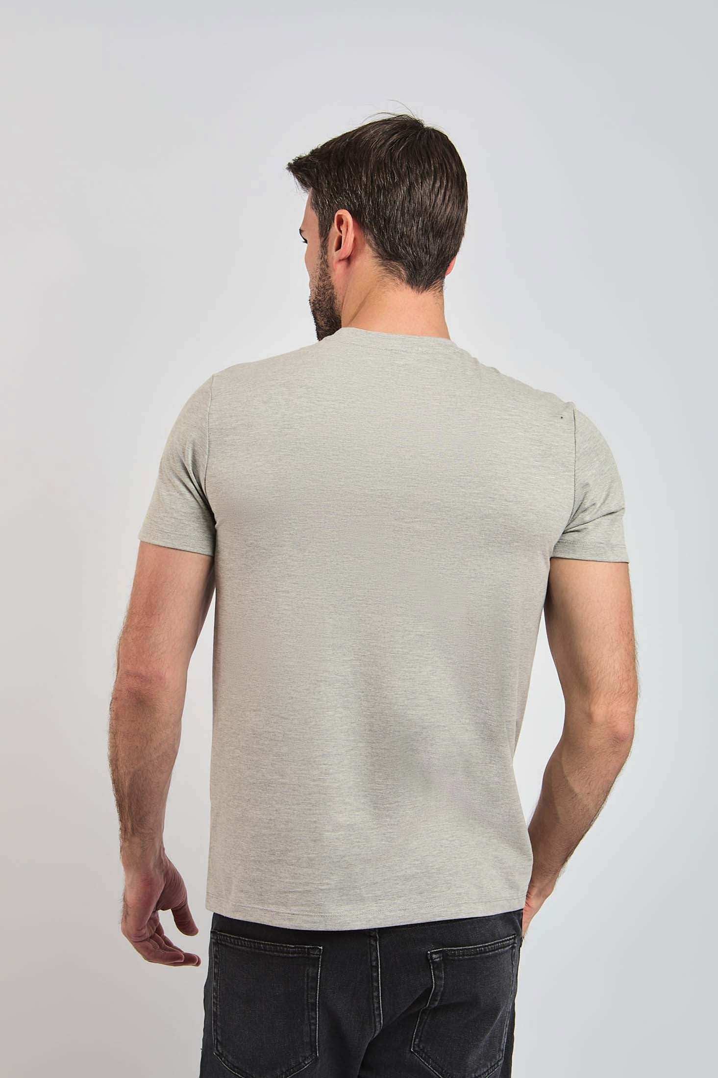 Back view of man wearing light grey Dalydress t-shirt and black jeans, casual menswear