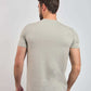 Back view of man wearing light grey Dalydress t-shirt and black jeans, casual menswear