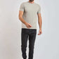 Dalydress men's fashion model in light grey t-shirt, dark jeans, and white sneakers