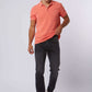 Man wearing coral polo shirt, black jeans, and white sneakers, Dalydress men's casual fashion
