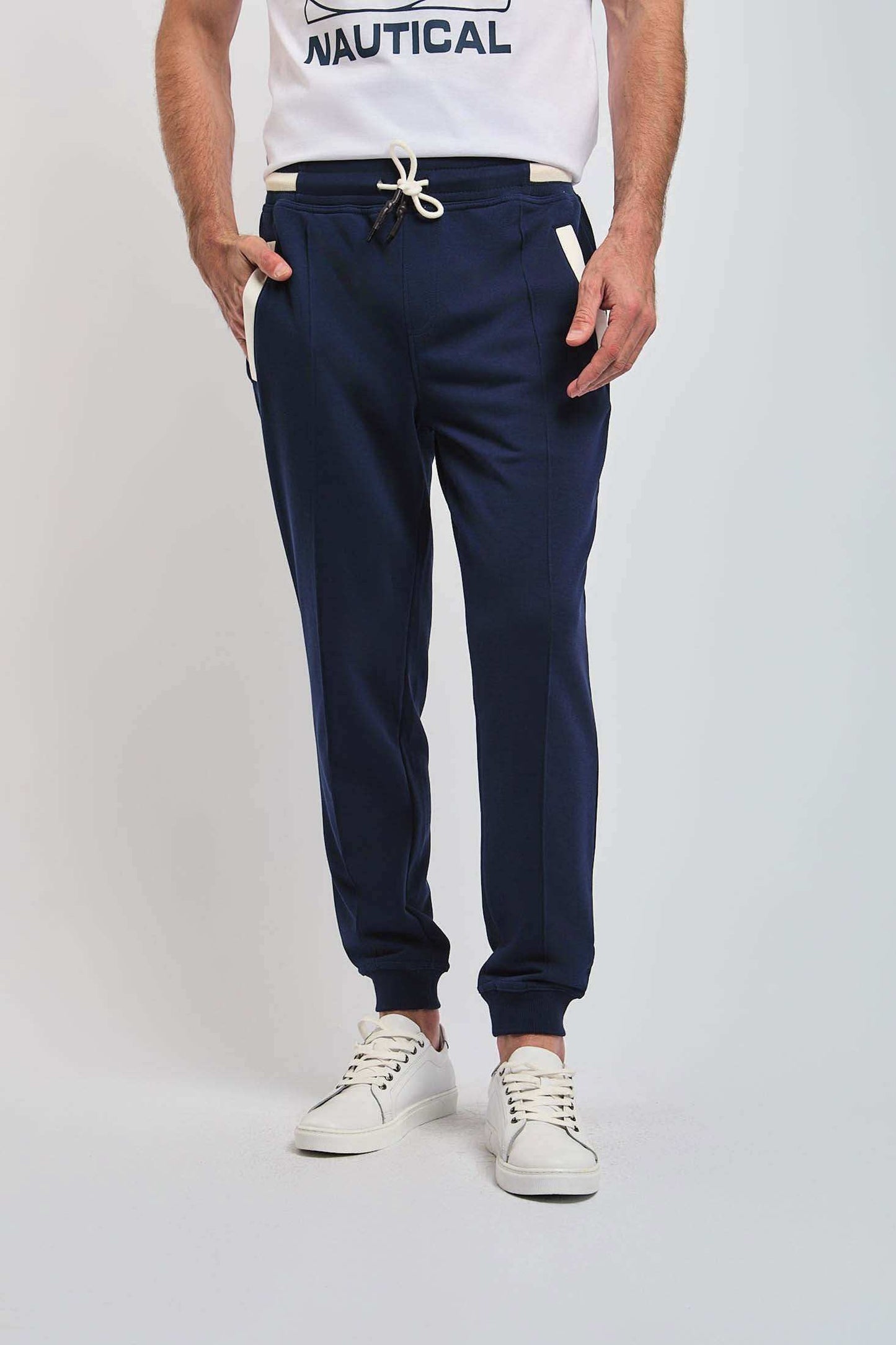 Dalydress men’s navy jogger pants with white drawstring and pockets, paired with white sneakers