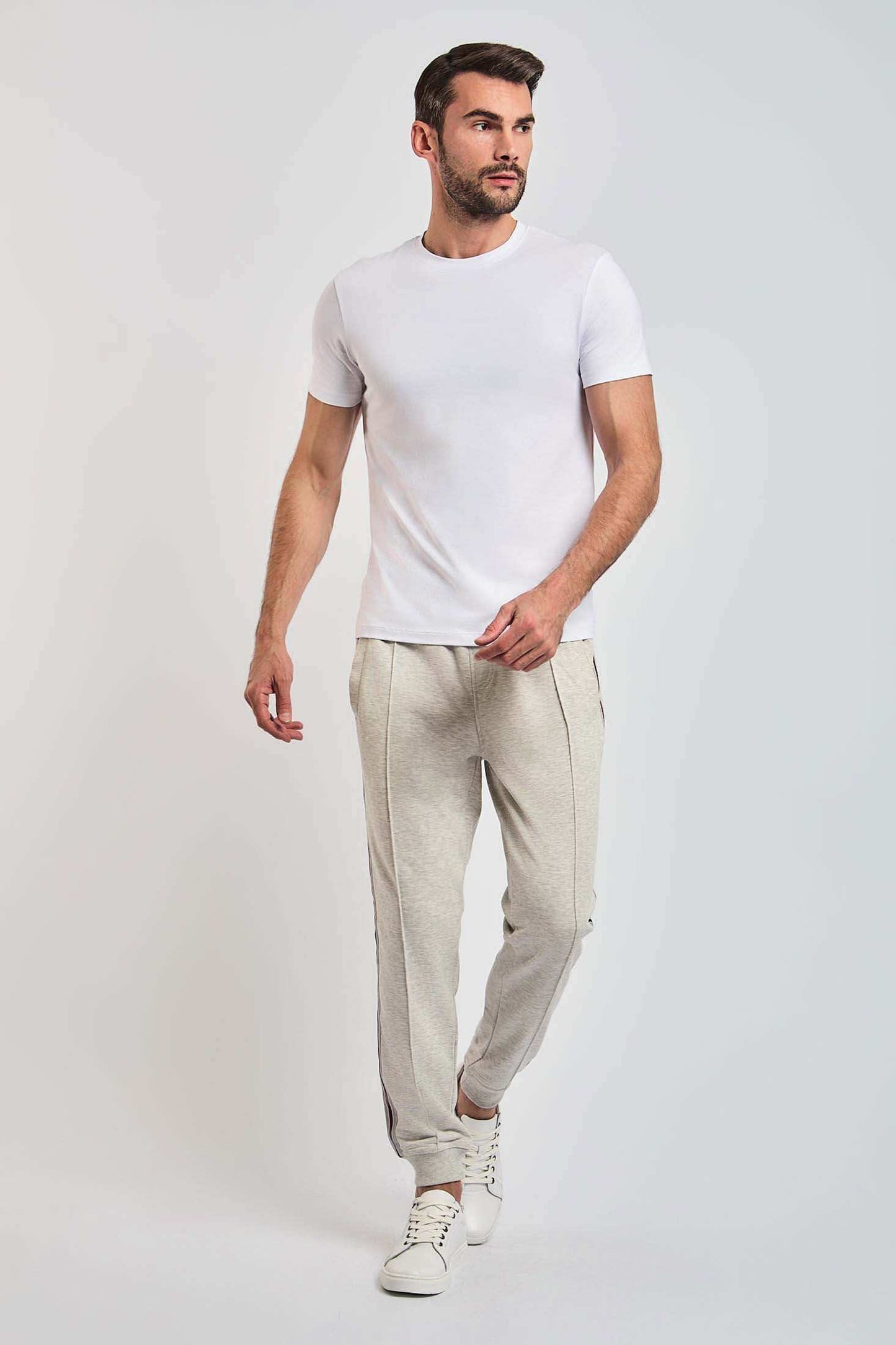 Dalydress men's casual wear, model in white t-shirt, beige pants, white sneakers