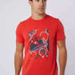 Man wearing Dalydress red graphic t-shirt with nautical print and blue jeans