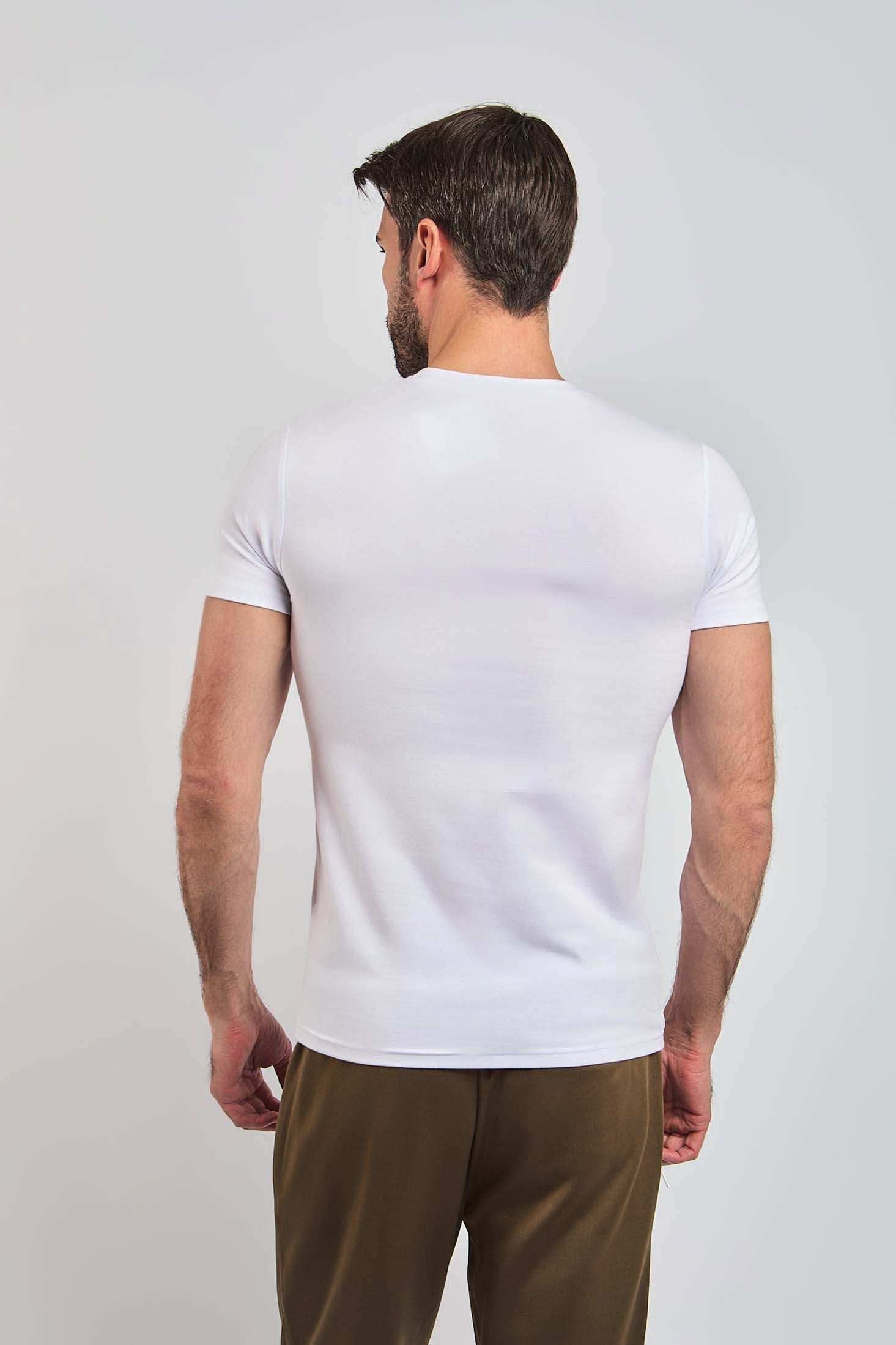 Man wearing plain white short-sleeve t-shirt and beige pants, back view