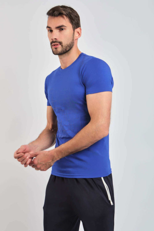 Man wearing a blue crew neck t-shirt and black casual pants with zipper pocket