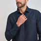 Man wearing a dark denim button-up shirt with chest pockets, casual men's fashion