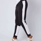 Men’s black jogger pants with white side stripes, casual athletic wear, white sneakers