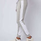 Men's grey jogger pants with white side stripes, casual style, side pockets, paired with white sneakers
