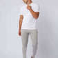 Man wearing white t-shirt and grey jogger pants with white stripes, casual outfit