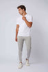 Man wearing white t-shirt and grey jogger pants with white stripes, casual outfit