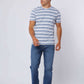 Man wearing blue and white striped t-shirt, blue jeans, and white sneakers