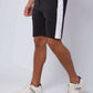 Men's black shorts with white side stripe, casual wear, styled with white sneakers
