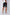 Men's black shorts with white side stripe, white sneakers, and white t-shirt, rear view