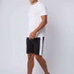 Man in casual white t-shirt, black shorts with white side stripe, and white sneakers