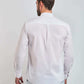 Man in white long sleeve shirt and light pants, back view, plain background