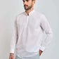 Man wearing a white mandarin collar long sleeve shirt and light pants, casual menswear