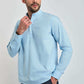 Man wearing a light blue mandarin collar long sleeve shirt with black trousers