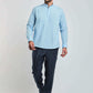 Man wearing a light blue mandarin collar shirt and dark trousers, casual fashion look