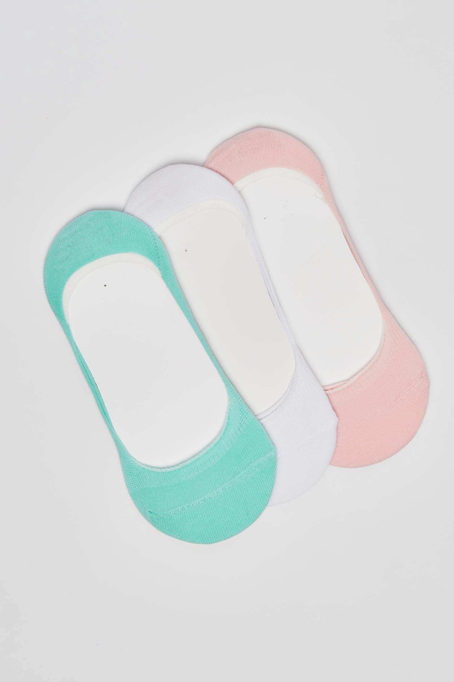 Set of three no-show socks in mint green, white, and pink on white background