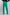 Woman wearing high-waisted green trousers and black heels, rear view