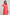 Woman in a coral pink long sleeve dress with waist tie and white cuff detail