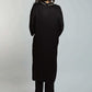 Woman in black long-sleeve tunic and pants set, back view, on plain background