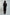 Woman in black long-sleeve tunic and pants set, back view, on plain background