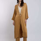Woman wearing camel brown kimono-style long cardigan with matching wide-leg pants and strappy heels