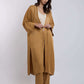 Woman in loose mustard yellow kimono jacket and pants set, neutral top, minimal style
