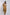 Woman in loose mustard yellow kimono jacket and pants set, neutral top, minimal style