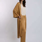 Woman wearing beige top with loose mustard kimono and matching wide-leg pants