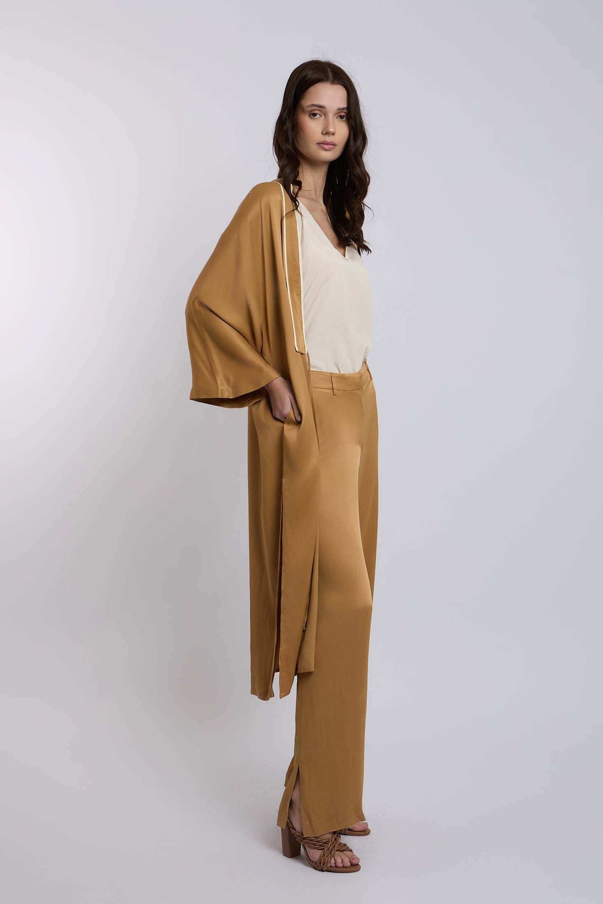 Woman wearing beige top with loose mustard kimono and matching wide-leg pants