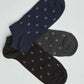 Set of three low-cut patterned socks in navy, gray, and black on a white background