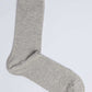 Light grey cotton sock on white background, casual men's or women's wear accessory