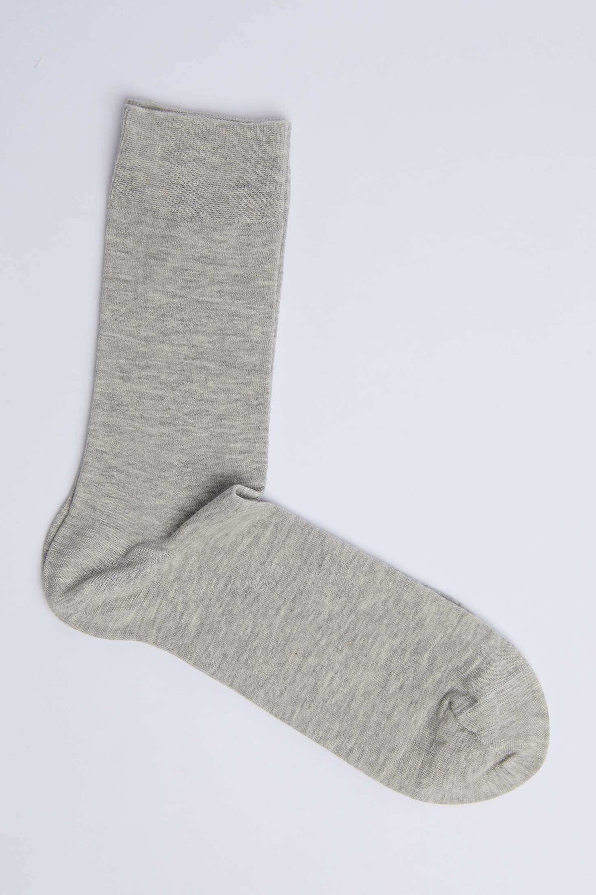 Light grey cotton sock on white background, casual men's or women's wear accessory