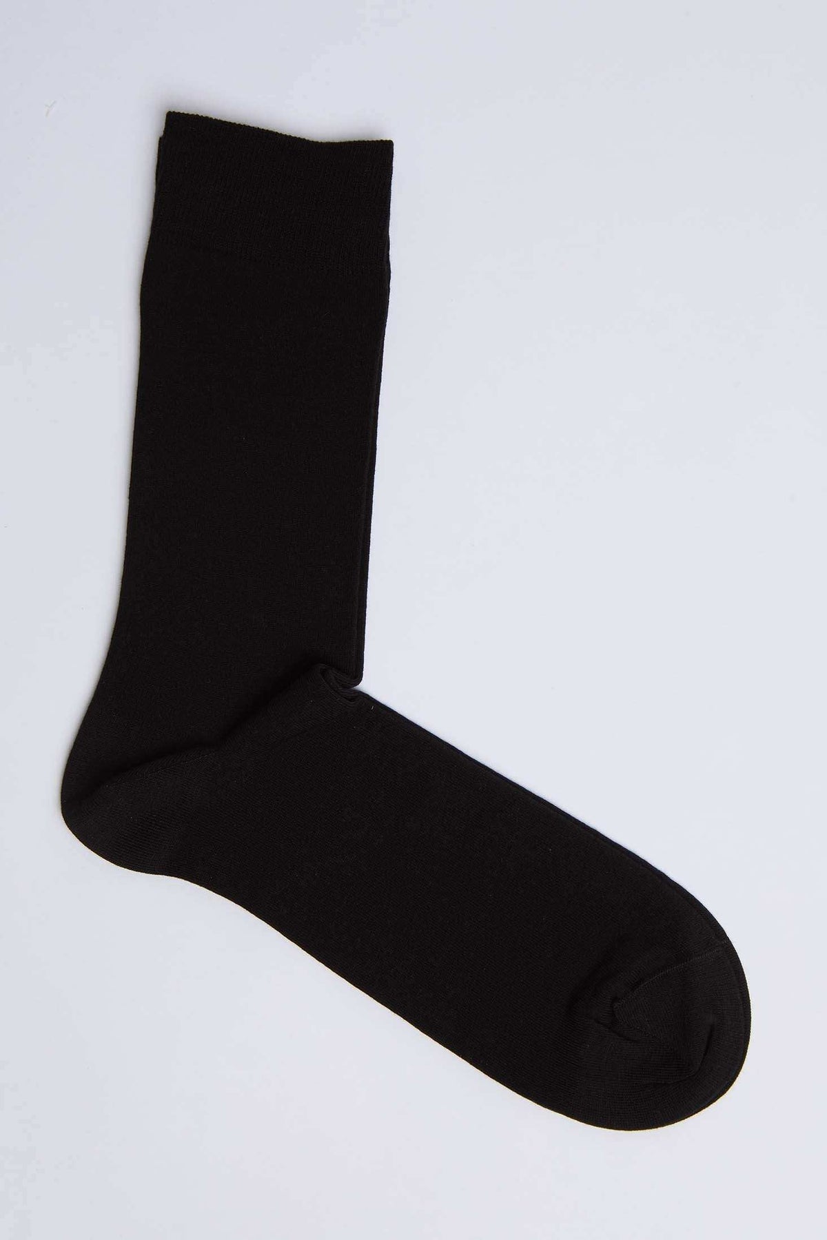 Plain black crew sock on a white background, casual men's or women's fashion accessory