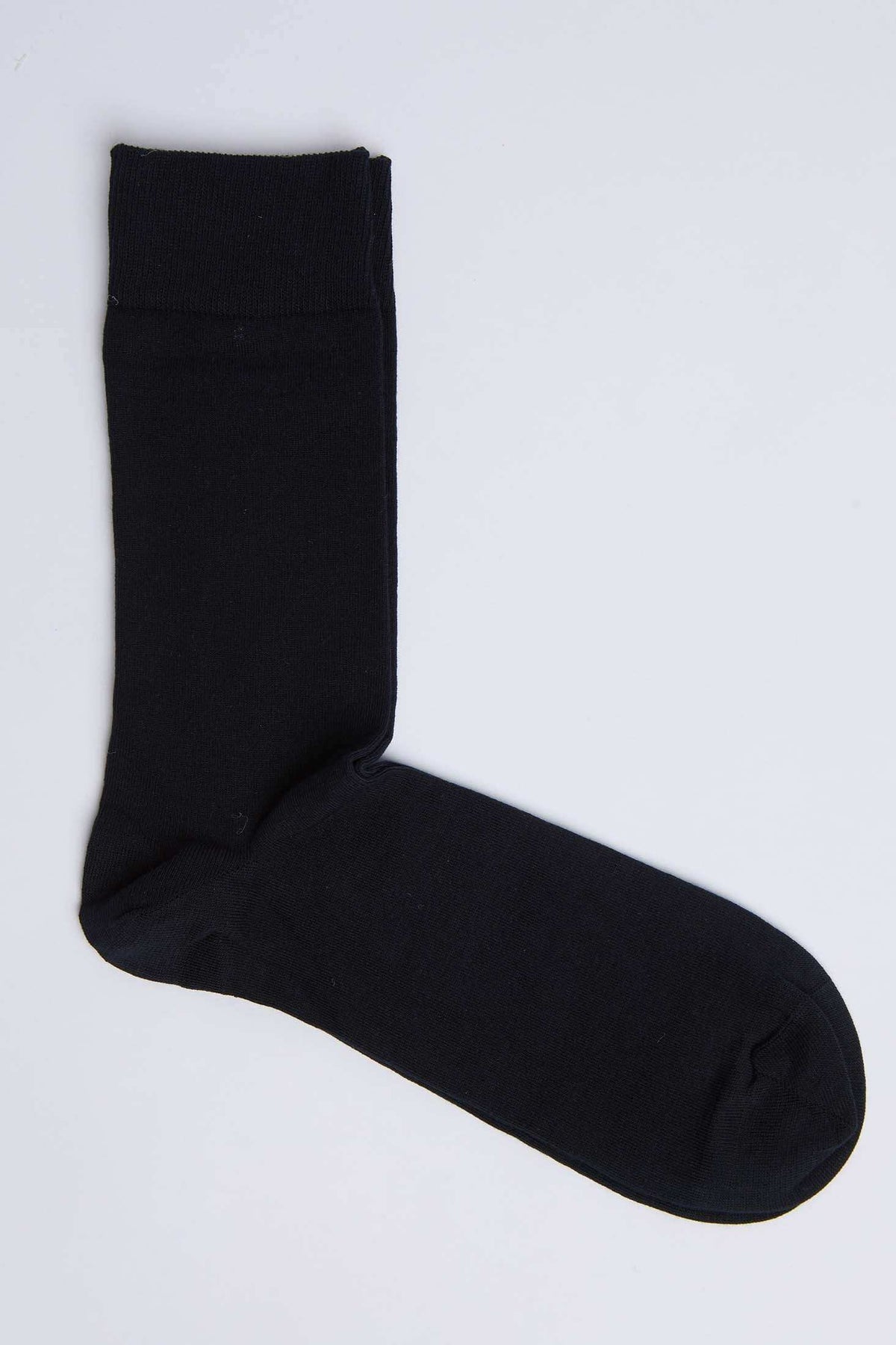 Black cotton crew sock on white background, casual men's or women's clothing accessory