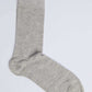Plain light grey crew sock on white background, casual cotton blend men's accessory