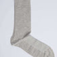 Light grey cotton sock on a plain white background, casual men's footwear accessory