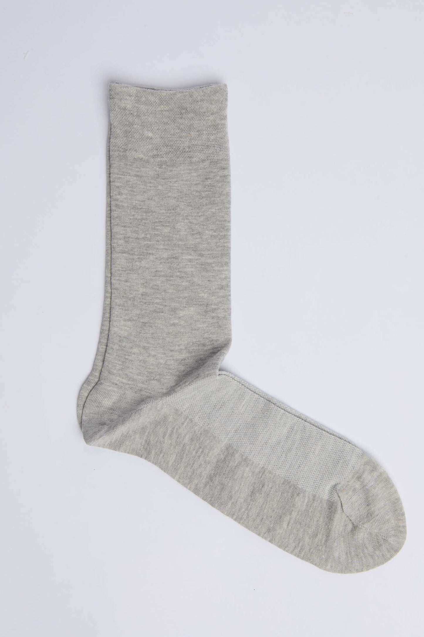 Light grey cotton sock on a plain white background, casual men's footwear accessory
