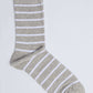 Grey and white striped men's dress sock on a plain background