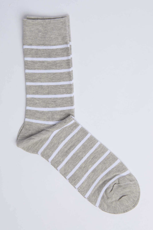 Grey and white striped men's dress sock on a plain background