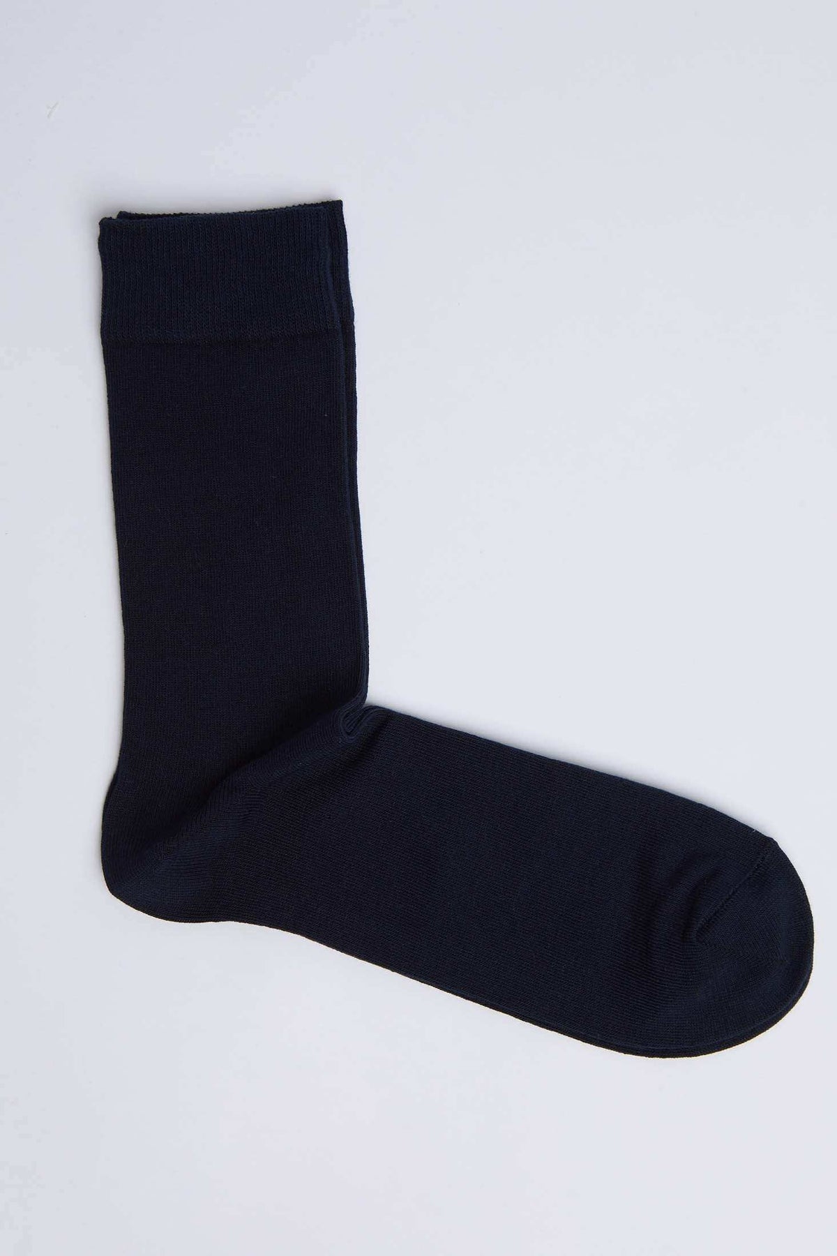 Plain black men's dress sock on a white background