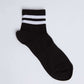 Black ankle sock with two white stripes, unisex casual wear, on white background